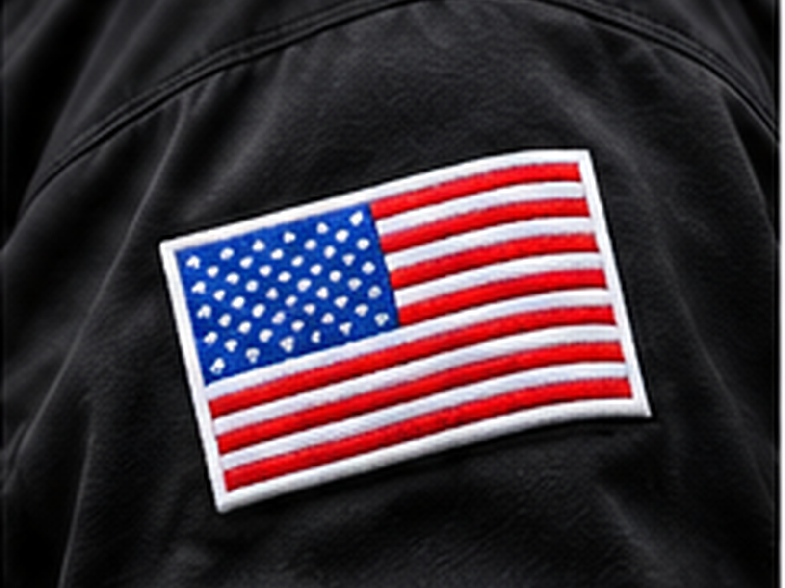 Embroidered American flag patch on black apparel